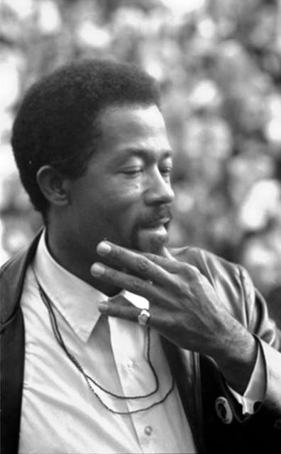 Eldridge Cleaver, 1968, in profile with hand to his chin. Contemplative expression.